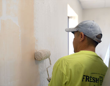 Commercial Painter meticulously painting a building interior - Commercial Painting Services in Minneapolis MN