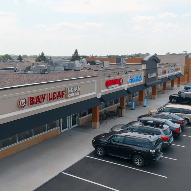 Commercial strip mall storefronts and parking lot